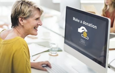 woman looking at a make a donation concept on a computer
